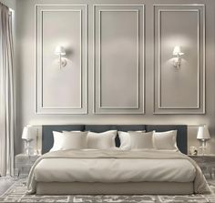 a large white bed sitting in a bedroom next to two wall lights and lamps on either side of the bed