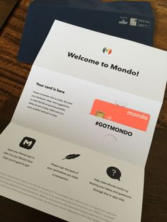 two different types of cards on top of a wooden table with the words welcome to mondo