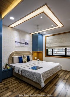 a bedroom with wood flooring and blue walls, along with a white bed in the middle