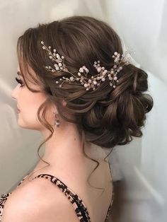 a woman wearing a hair comb with flowers in it