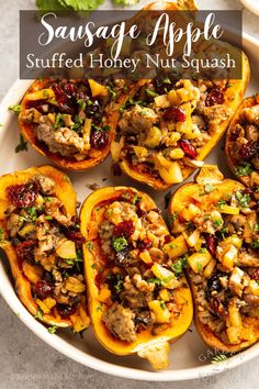 stuffed bell peppers with meat and cranberry sauce in a white dish on a table