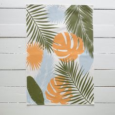 an orange and green palm leaf print on a white wall