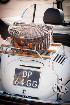 an old car with a basket on the back