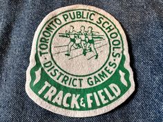 a patch that says toronto public school district games track and field on the back of a pair of jeans