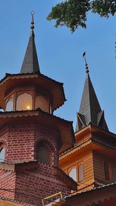 an old brick building with two towers on top