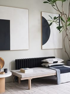 a living room with two paintings on the wall