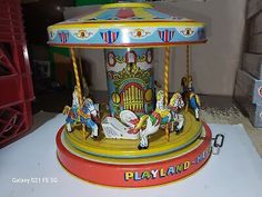 a merry go round toy with horses on it's sides and the name playland