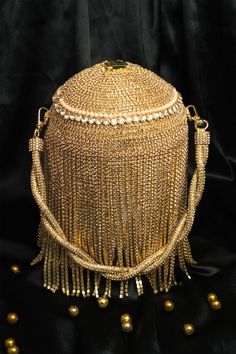 Gold cylindrical shaped potli with diamante tassel embellishment. Comes with detachable handle. - Aza Fashions Elegant Potli Bag With Tassels For Reception, Traditional Tassel Potli Bag For Reception, Gold Potli Bag With Tassels For Party, Glamorous Gold Potli Bag For Evening, Luxury Embellished Potli Bag For Evening, Festival Reception Potli Bag With Latkans, Traditional Tassel Bags For Reception, Festive Potli Bag With Latkans For Receptions, Gold Embellished Potli Bag For Reception