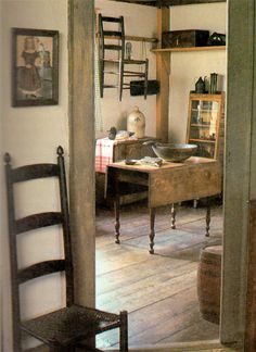 an old fashioned desk and chair in a room with wood flooring on the walls