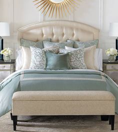 a bedroom with a large bed covered in blue and white pillows