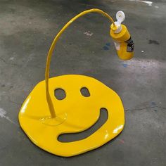 a yellow fire hydrant with a smiley face on it