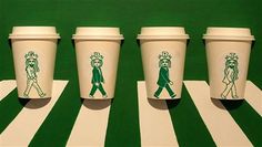 four starbucks cups with the same drawing on them, all lined up in different directions