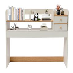 a white desk with books and other items on top of it, against a white background