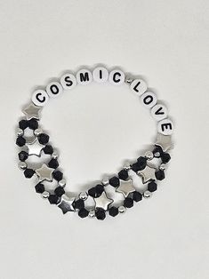 Visit bejeweledbangles.com for better pricing! This gorgeous bracelet is made of black and silver metal beads with accent stars, "Cosmic Love" in white beads with black writing. This bracelet is so pretty and you will love wearing it proudly or gift it to a friend! Bracelet is made with elastic and various bead types. Tortured Poets Department Bracelet, Lyric Bracelet, Taylor Bracelets, Taylor Bracelet, Bead Types, Teddy Lupin, Swift Bracelets, Cosmic Love, Down Bad