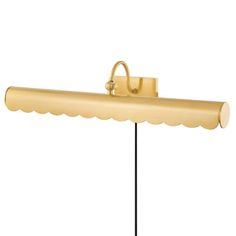 a gold wall light with a scalloped shade on the side and a black stand