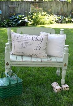 a bench with pillows and dice on the grass