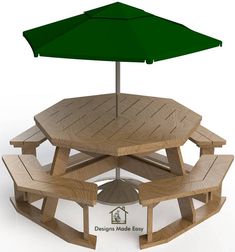 a wooden picnic table with two green umbrellas over it and benches underneath the table