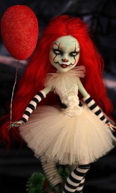 a creepy doll with red hair and makeup holds a balloon in her hand while wearing a white dress