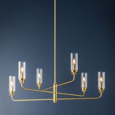 a brass chandelier with clear glass shades