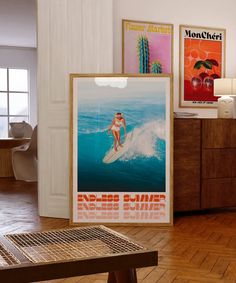 there are posters on the wall in this living room, including a surfboarder