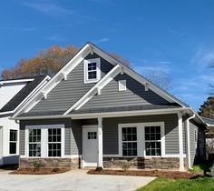 a gray house with white trim and windows