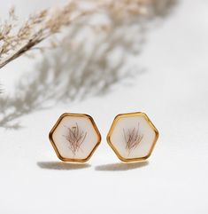 Nice gift idea for moms, best friends or to keep for yourself. Stainless steel earrings with pressed flowers. Hexagonal earrings, brass setting Diameter: 12mm Material plug: stainless steel Our new collection is here! Botanical Collection is a tribute to the lush beauty of nature. We want to capture it, this exuberant beauty, in jewelry of course. Like all our jewelry, the pieces in this collection are also elaborately handcrafted. We do not buy ready-pressed flowers. All flowers and plants are Nickel-free Hexagon Earrings For Gift, Nickel-free Hexagon Earrings As A Gift, Botanical Collection, Design Flower, Steel Earrings, All Flowers, Stainless Steel Earrings, Pressed Flowers, Flower Earrings