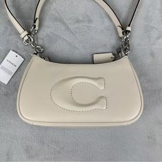 Measurements: Height 6" Width 10" Hand Strap 7" Shoulder Strap 20" Inside Purse 5" Color White Trendy Coach Shoulder Bag For Errands, Coach Handheld Shoulder Bag, White Coach Purse, Coach Leather Handbags, Coach Bucket Bag, Inside Purse, Saddle Handbags, Tan Handbags, Patent Leather Handbags