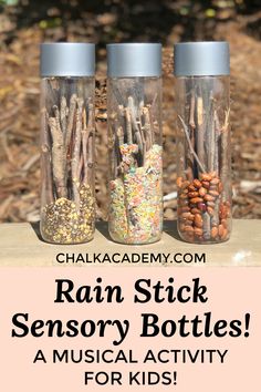 three glass jars filled with sticks and nuts on top of a wooden table next to the words rain stick sensory bottles musical activity for kids