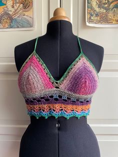 a mannequin wearing a multicolored halter top with crochet