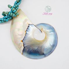 The White Nautilus shell is from Netherland and crafted in Indonesia. The Necklace is made of small Light blue Racine beads string together each bead to be a beading line and twist each line to be one line to stronger and look beautiful, and it is 18 inches long, weight 45g. (including pendant)   It's a real seashell from farming which it's fed by the seaweed, not from the natural environment due to environmental conservation. Our product was crafted with craftsmanship from one generation to one generation, and it may not last forever. Unlike a product that is made by machine. It's not just an ordinary necklace but it's about the taste of the wearer. It's for you or anyone who infatuates nature which each of the shells may look alike but not the same in color and texture. It's very UNIQUE. Blue Shell-shaped Handmade Jewelry, Handmade Blue Shell Jewelry, Beaded Mother Of Pearl Shell As Gift, Mother Of Pearl Beaded Shell As Gift, Handmade Blue Shell Beaded Necklaces, Handmade Blue Shell, Blue Mother Of Pearl Jewelry For Beach, Beaded Shell Necklace With Mother Of Pearl Round Beads, Beaded Shell Necklace With Round Mother Of Pearl Beads