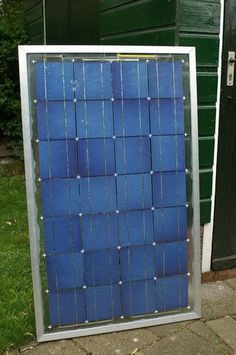 a blue solar panel sitting on top of a metal pole