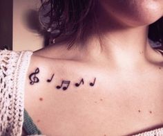 a woman with musical notes tattooed on her chest