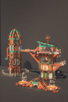 an orange and green building made out of legos on top of a gray surface