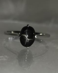 Brand : Walifine Jewellers  Material : 925 Sterling Silver  Gemstone : 100% Natural Black Star  Black Star Stone Weight : 1.35 Carat  Black Star Stone Size : 6×8 MM  Gross weight : 2.04 GM Approx....  Stone Shape : Oval  Ring Size : All Size Available  Occasion : For Every Occasion  * Benefits of Black Star:- Grounding and Stability. Black Star Diopside is believed to have grounding properties, providing stability to those who wear or connect with the gemstone. ...  * Enhanced Spiritual Connecti Star-shaped Gemstone Rings For Gifts, Star-shaped 925 Sterling Silver Rings For Gifts, Star-shaped Stamped 925 Silver Ring As Gift, Star-shaped Stamped 925 Silver Jewelry Gift, Star Shaped Stamped 925 Silver Jewelry Gift, Silver Bridesmaid, March Birthstone, Oval Rings, Star Ring