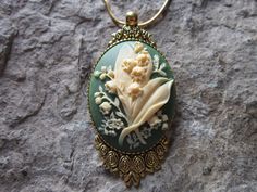 "Beautiful lily of the valley cameo necklaces, other colors available, please do browse and message me with your choice!! The cameos are gorgeous I do have many other colors and styles, so please do browse, I can make any larger cameo in my shop into this pretty necklace, so browse and message me with a custom order The pretty setting is classically beautiful, about 2 1/4\" long. The chain is a matching 24\" gold plated snake chin with a lobster claw clasp. Perfect for Brides or Bridal parties. Green Flower Pendant Necklace For Wedding, Green Victorian Necklace For Wedding, Delicate Green Necklace For Wedding, Victorian Flower Pendant Necklaces For Wedding, Victorian Flower Pendant Necklace For Wedding, Antique Flower Necklaces For Weddings, Victorian Wedding Necklace With Flower Pendant, Lily Wedding, Cameo Jewelry