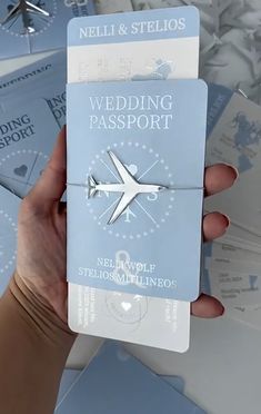 a person holding up a wedding passport in their hand