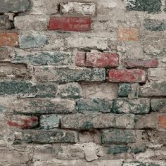 an old brick wall with red and white bricks