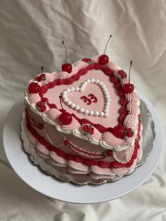 a heart shaped cake with cherries on top