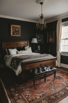 a bedroom with a large bed and chandelier hanging from it's ceiling