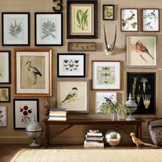 a living room filled with lots of framed pictures