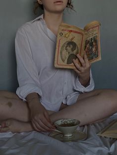 a woman sitting on the floor reading a book