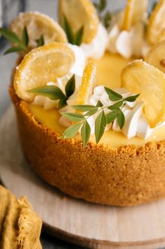 a cheesecake topped with lemon slices and whipped cream