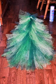 a small green christmas tree on the floor