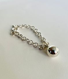 This simple and elegant sterling silver globe bracelet has been hand formed and polished by me. The bracelet is made of %100 925 sterling silver. The bracelet is minimalist, elegant and unique. So it is a comfortable to wear for any occassion. It is also perfect as statement bracelet. It will be a great gift for chunky and bold bracelet lovers! You may also check my '' Silver Globe Ring '' from the '' Rings '' section for to make perfect match! ------------------------------------------------------------------------------------------------------------------------------------------------------------ SIZES: Diameter of the globe is 16 mm From 6 to 10 inches including half sizes. If you need a size other than listed, please let me know, and I will customize the size for you. P.S: Custom sizes Silver Ball Chain Bracelet For Everyday, Silver Ball Jewelry, Elegant Silver Ball Chain Bracelet, Elegant Sterling Silver Ball Chain Bracelet, Silver Ball Bracelet, Chunky Silver Bracelet, Chunky Charm Bracelet, Jewelry Statement, Statement Bracelet