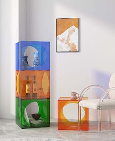 a colorful display case sitting in the middle of a room next to a white chair