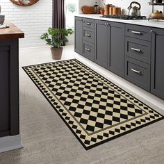 a black and white checkered rug in a kitchen