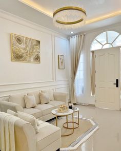 a living room filled with furniture and a chandelier