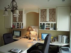 a home office with desk, chair and lamp in the corner by the bookshelf