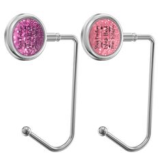 two metal hooks with pink glitter on them