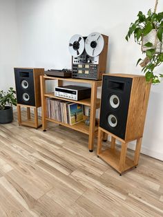 there are two speakers and a stereo on the stand next to each other in this room